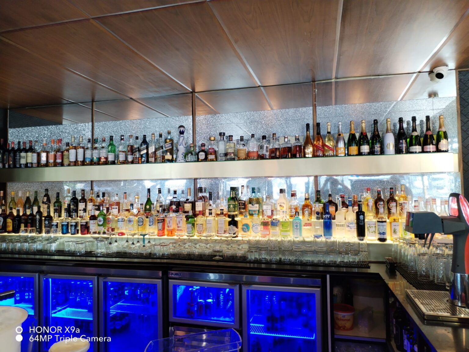 Backlit bar shelving with mirrored glass back panels