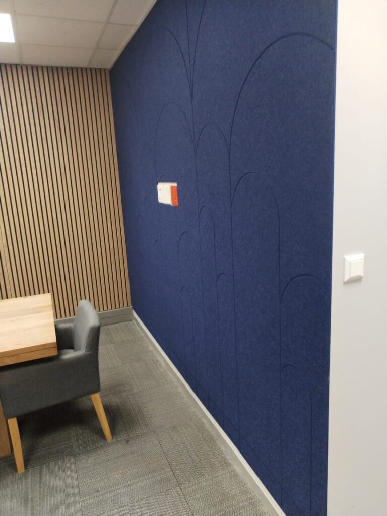 Meeting room with navy acoustic felt feature wall and oak slat panelling