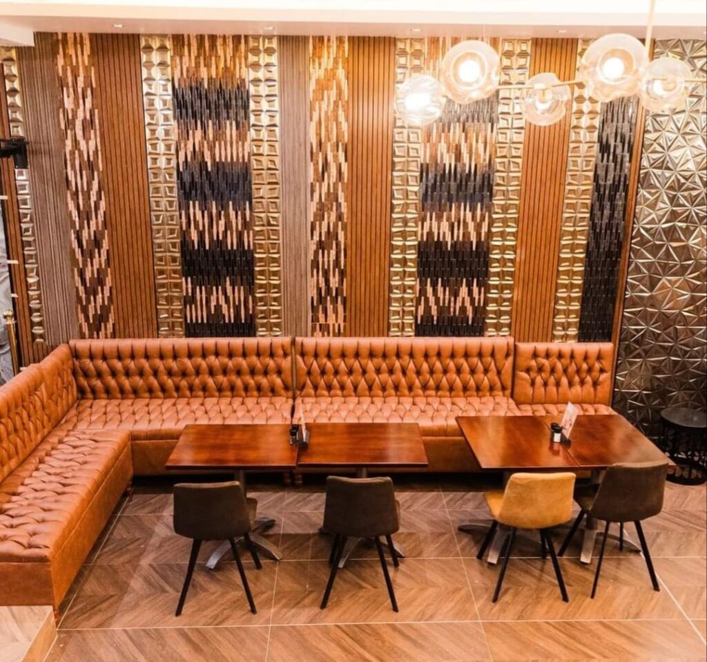 Restaurant booth seating with timber and panelled feature wall