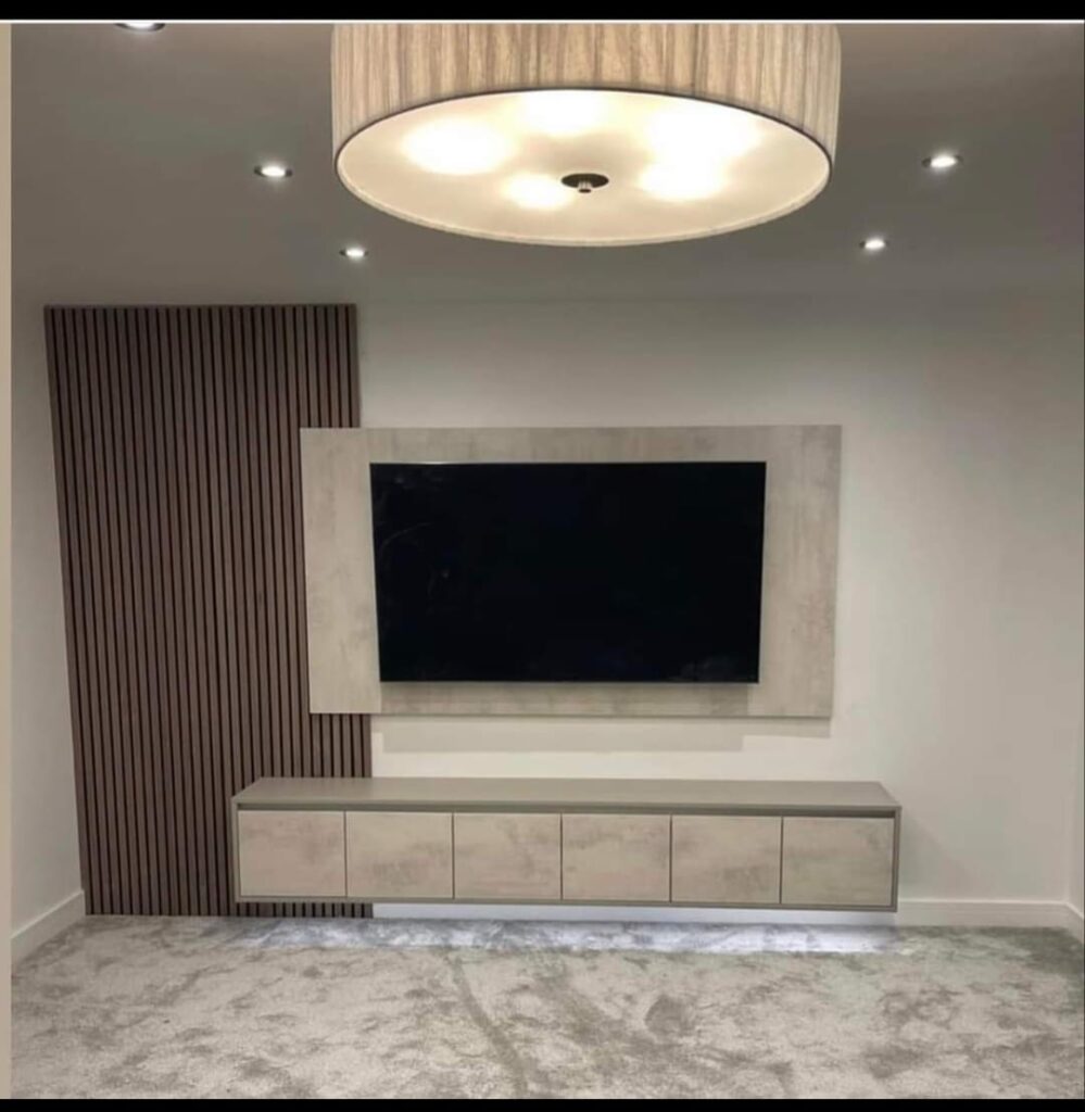 Built-in media unit with stone-finish panel and slatted timber wall